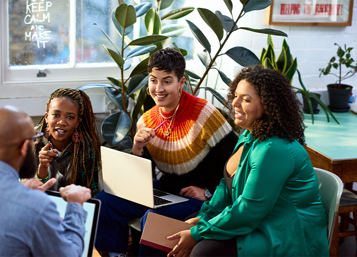 Diverse group of casual business women engaged in lively conversation