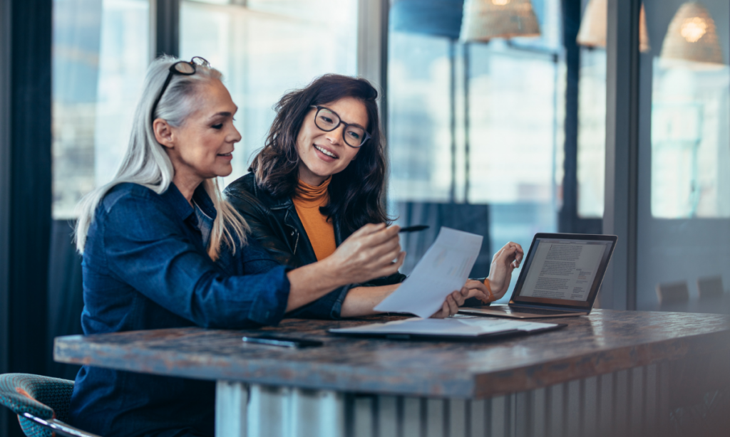 A marketing manager reviewing marketing campaign results with her team member