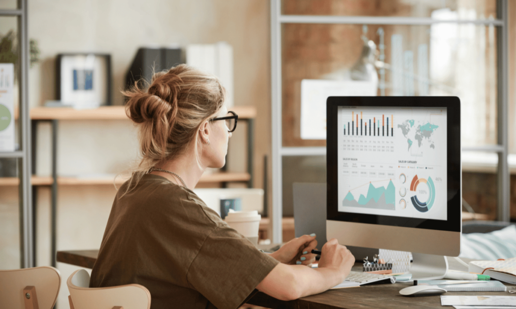 young blonde woman responsible for ppc marketing in front of computer